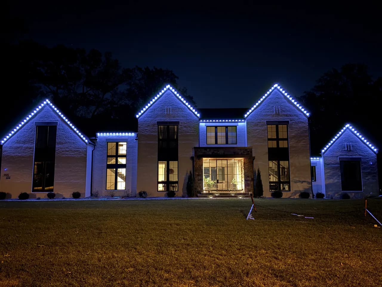 Permanent LED lighting in Vienna, VA by Light DMV — multi-gable home with a crisp warm-white roofline at night