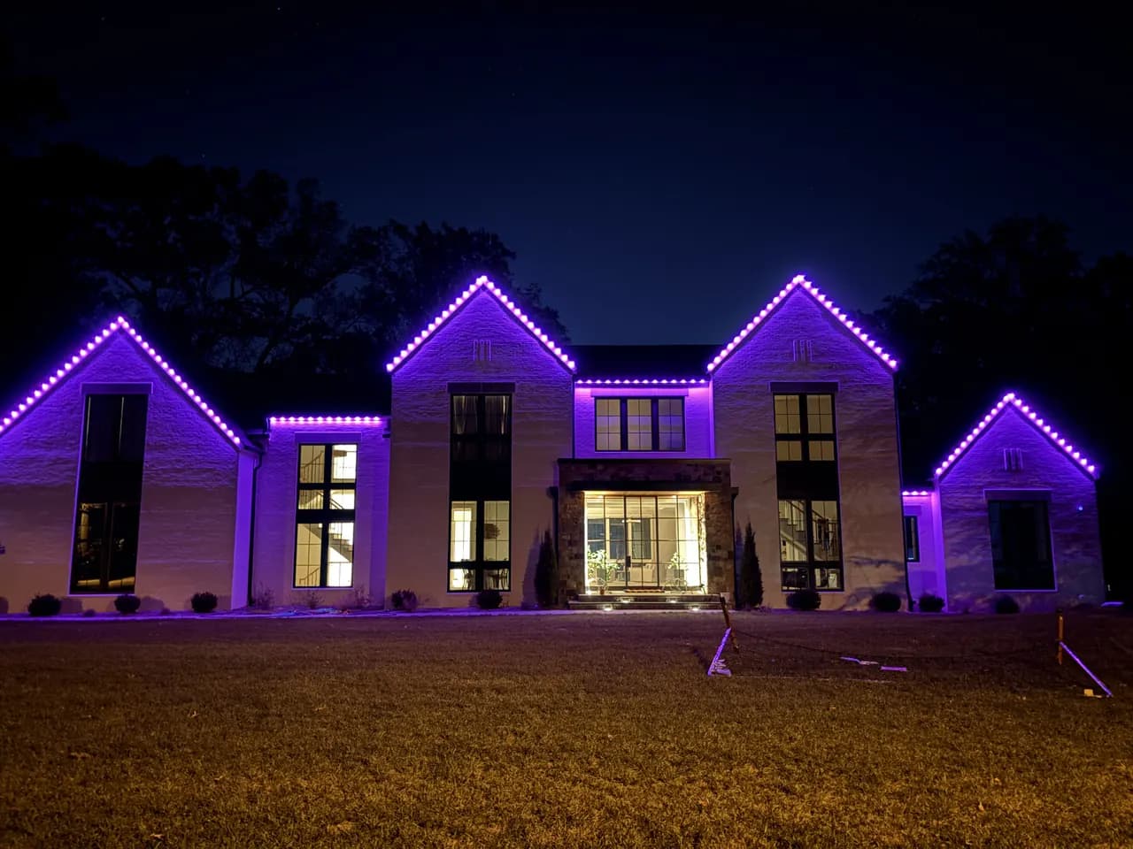 Permanent LED lighting in Vienna, VA by Light DMV — same roofline lit purple for a custom scene at night