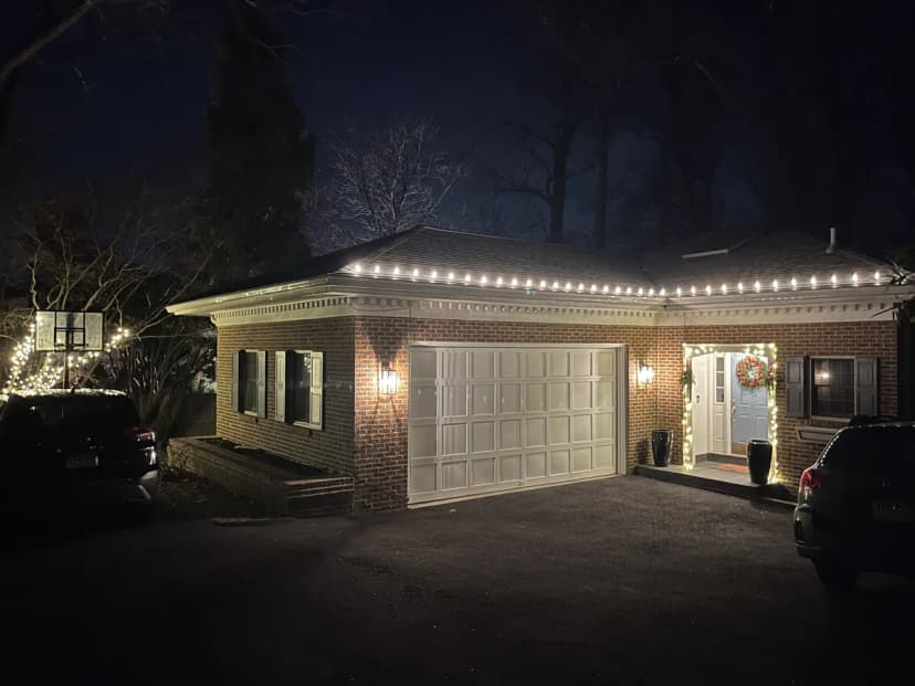 Compact Germantown home with clean warm-white C9 roofline lighting + simple entry wreath — HOA-friendly Christmas light installation by Light DMV for Milestone and Churchill homes