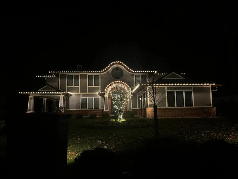 Christmas light installation in the DMV by Light DMV — warm white roofline on a large two-story home