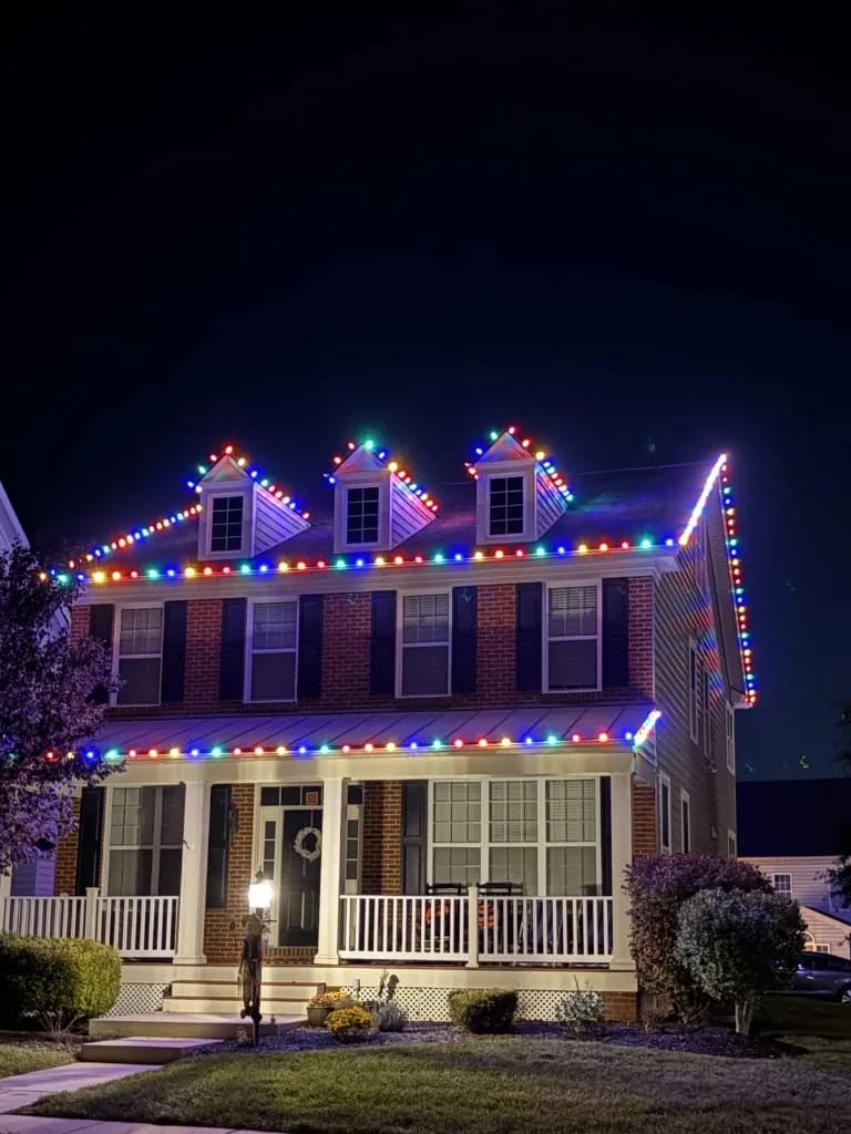 Christmas light installation in the DMV by Light DMV — colorful C9 roofline on a brick home
