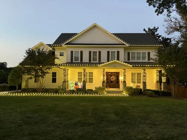 Christmas light installation in the DMV by Light DMV — warm white roofline on a colonial home
