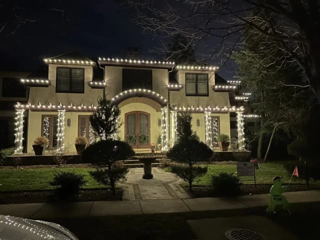 Christmas light installation in the DMV by Light DMV — icicle and roofline lighting in snow