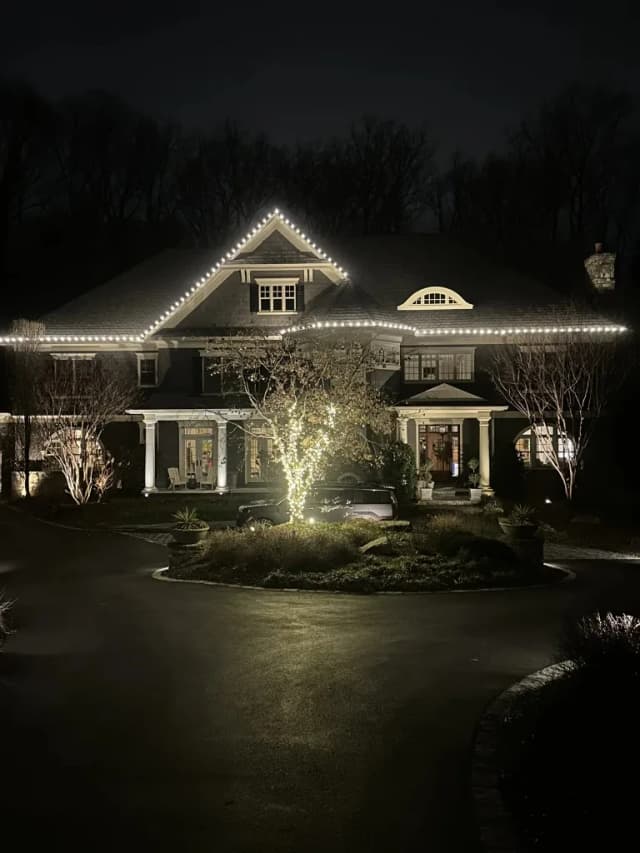 Christmas light installation in the DMV by Light DMV — bright warm white holiday lights on a symmetrical home