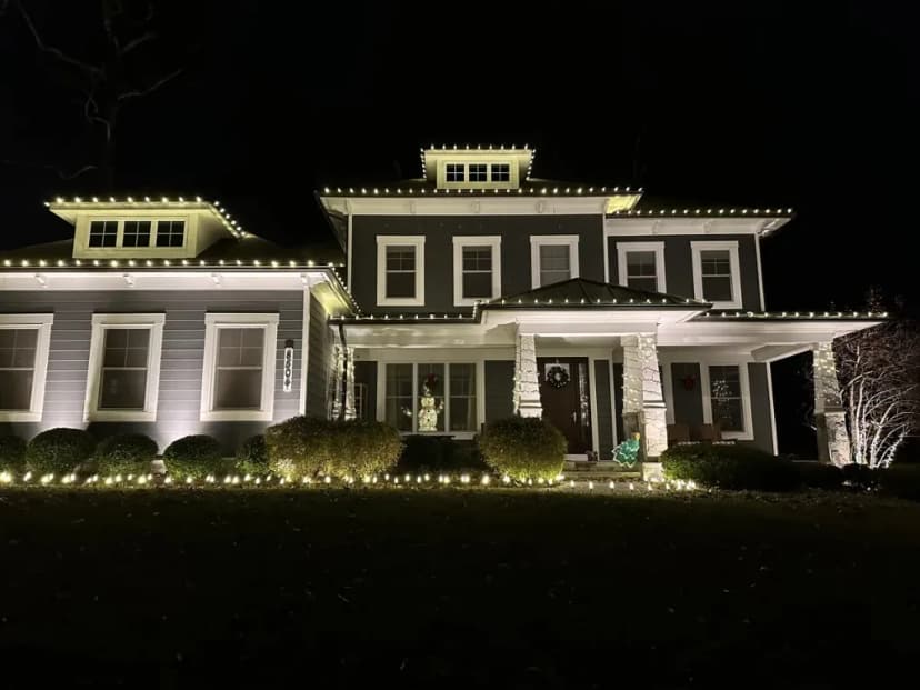 Christmas light installation in the DMV by Light DMV — warm white roofline on a two-story custom home