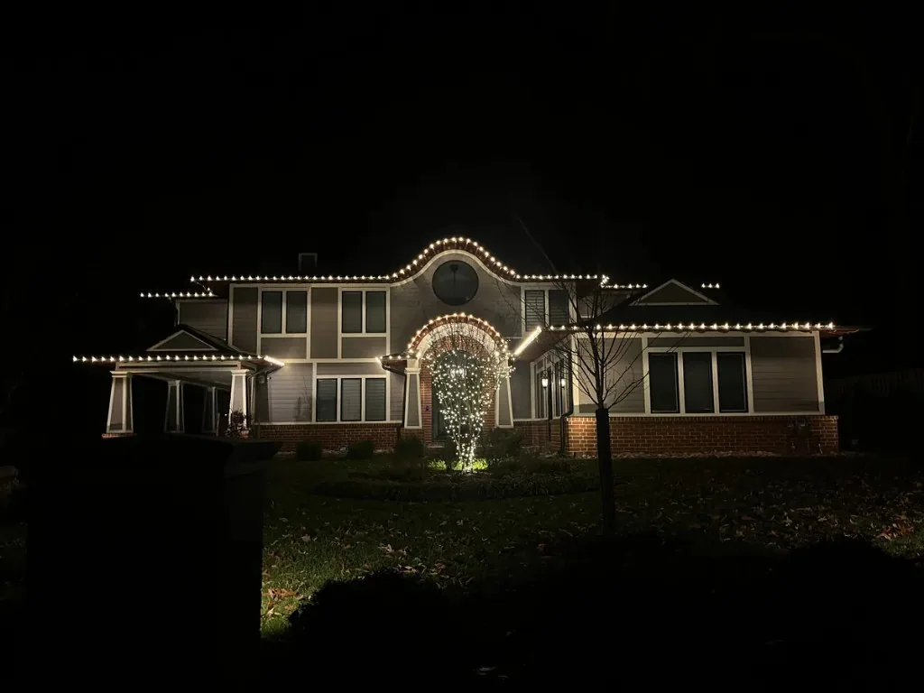 Christmas light installation in the DMV — warm white roofline on a large two-story home